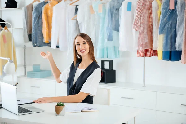 Female worker of modern dry-cleaner's at reception — Stock Photo, Image