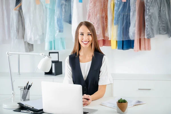 Female worker of modern dry-cleaner's at reception — Stock Photo, Image