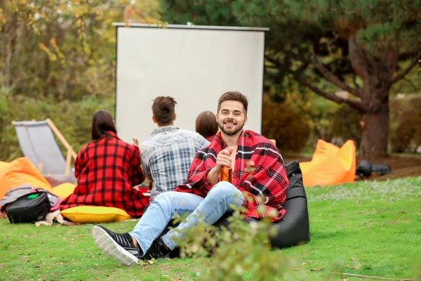 Happy young man in outdoor cinema — Stock Photo, Image