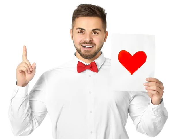 Schöner Mann mit Grußkarte auf weißem Hintergrund. Valentinstag-Feier — Stockfoto