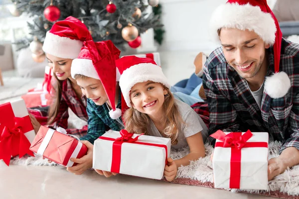 Happy family with Christmas gifts at home — Stock Photo, Image
