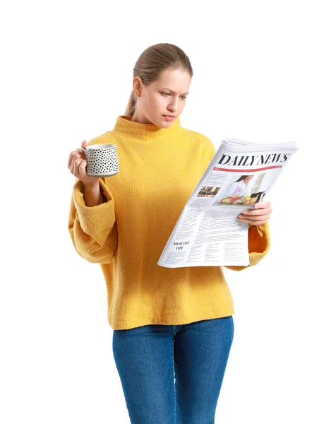 Young woman with newspaper and cup of coffee on white background — Stock Photo, Image