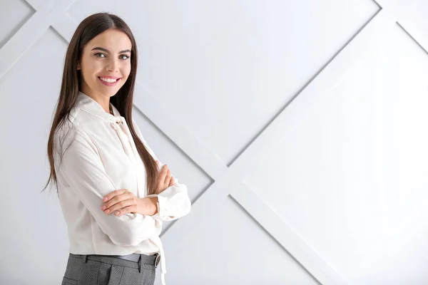 Beautiful young businesswoman on light background — Stock Photo, Image