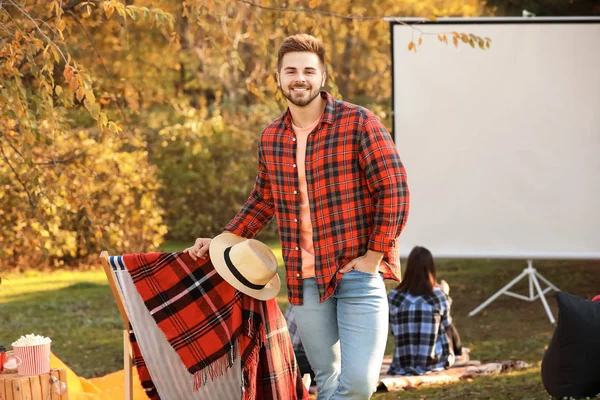 Young man in outdoor cinema