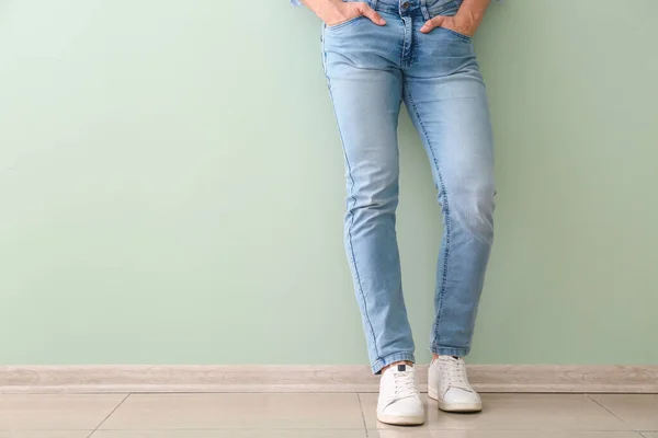 Hombre joven en zapatos elegantes cerca de la pared de color —  Fotos de Stock