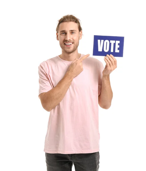 Young man holding paper with text VOTE on white background — Stock Photo, Image