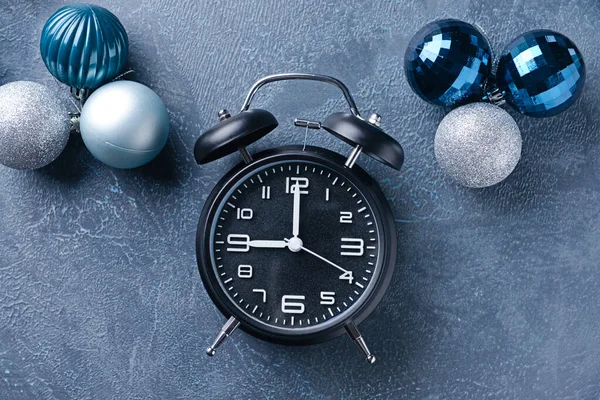 Wekker klok en decor op kleur achtergrond. Kerst countdown concept — Stockfoto