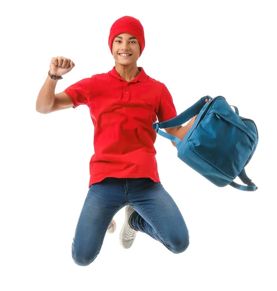 Saltando menino adolescente afro-americano com mochila no fundo branco — Fotografia de Stock