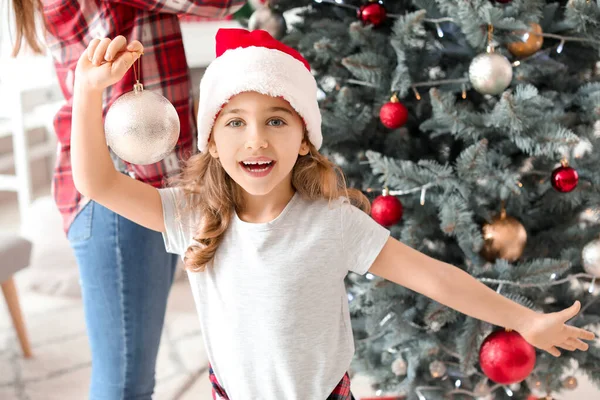 Little girl and her mother decorating Christmas tree at home — Stock Photo, Image