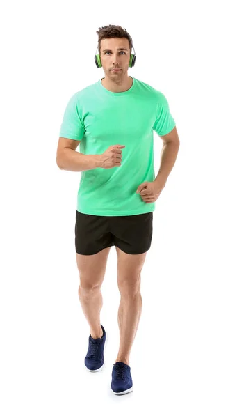 Sportlich laufender junger Mann auf weißem Hintergrund — Stockfoto