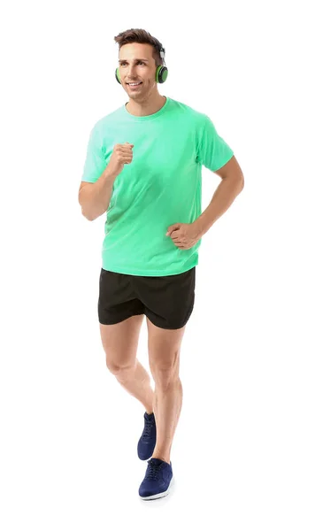Sportovní běží mladý muž na bílém pozadí — Stock fotografie