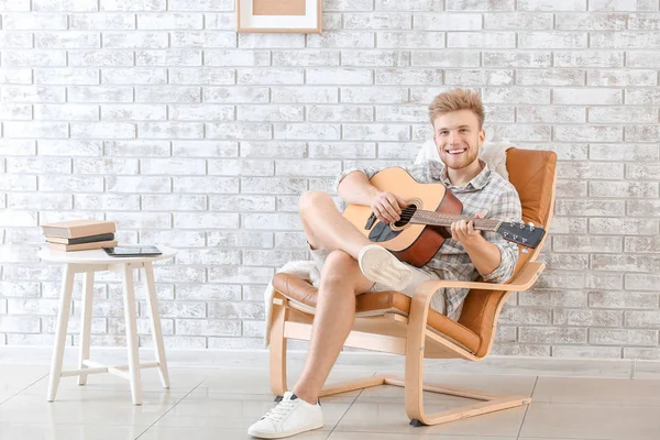 Handsome man playing guitar at home — Stock Photo, Image