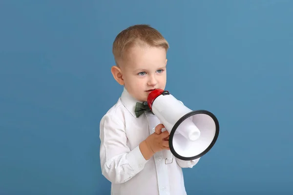 Portrait of cute little boy with megaphone on color background — Stock Photo, Image