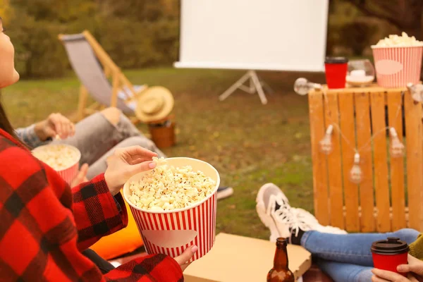 Friends watching movie in outdoor cinema