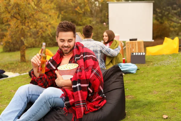 Happy young man in outdoor cinema — Stock Photo, Image