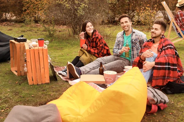 Friends watching movie in outdoor cinema