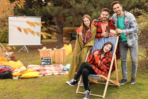 Happy friends in outdoor cinema