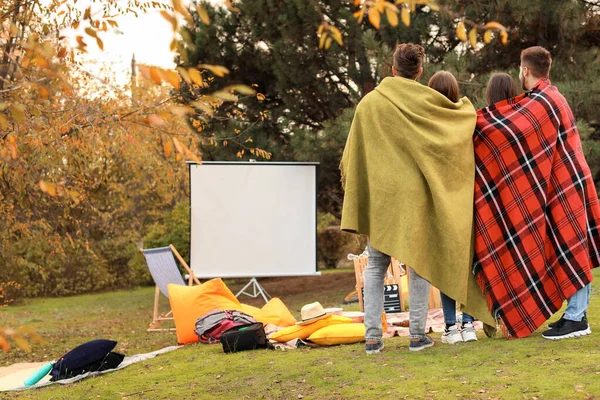 Friends watching movie in outdoor cinema