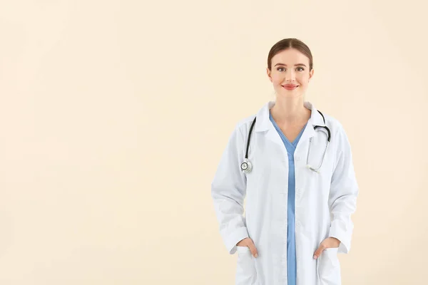 Portrait of female doctor on light background — Stock Photo, Image
