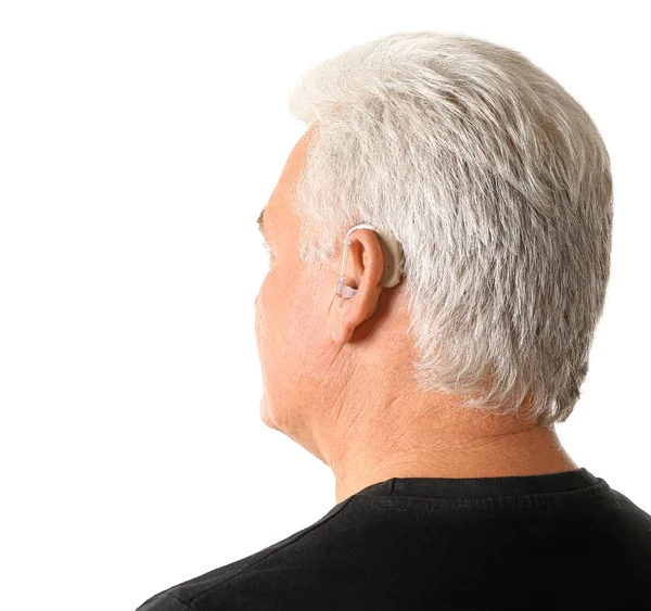 Mature man with hearing aid on white background — Stock Photo, Image