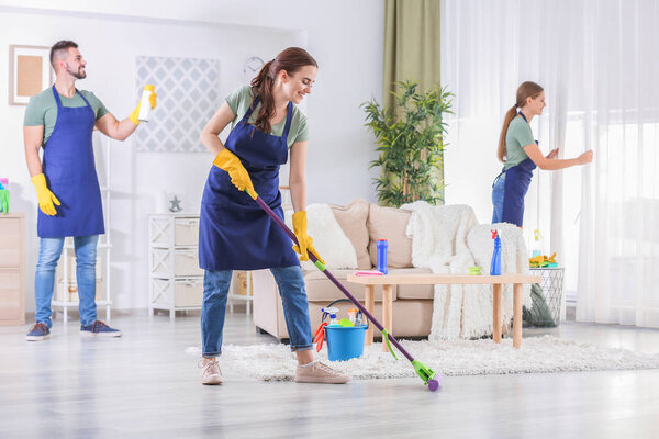 Team of janitors cleaning room