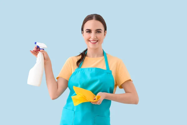 Female janitor on color background — Stock Photo, Image