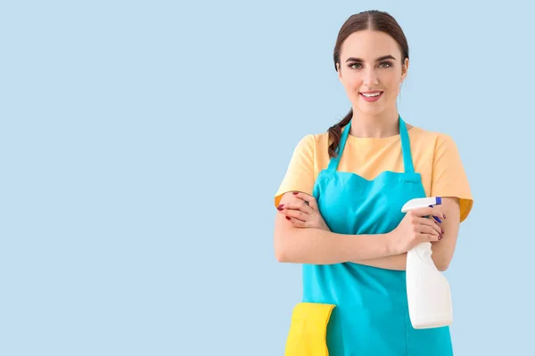 Female janitor on color background — Stock Photo, Image