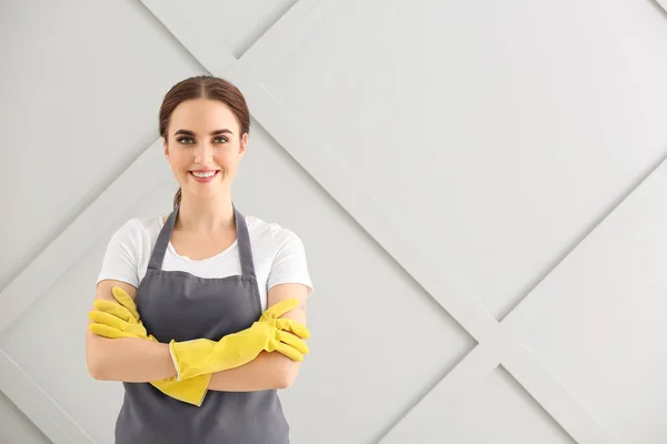 Female janitor on grey background — Stock Photo, Image