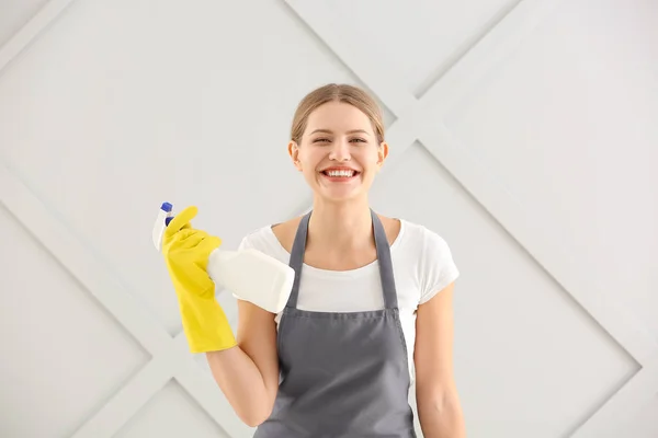 Female janitor on grey background — Stock Photo, Image