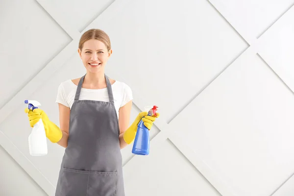 Female janitor on grey background — Stock Photo, Image