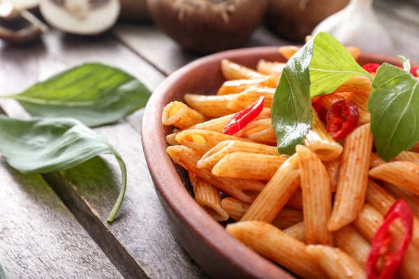 Plate with tasty pasta on wooden table — Stock Photo, Image