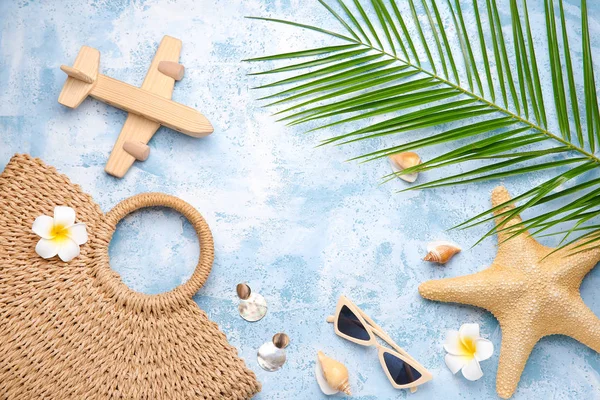 Set of beach accessories with wooden airplane on color background — Stock Photo, Image