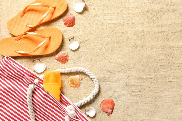 Set of beach accessories with seashells on sand — Stock Photo, Image