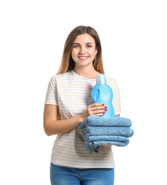 Beautiful young woman with laundry on white background