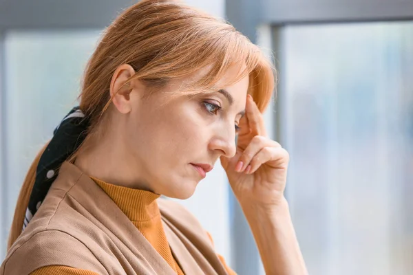 Portrait of depressed woman near window — Stock Photo, Image