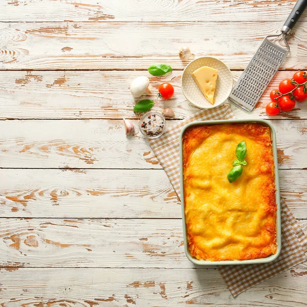 Tasty baked lasagna on white wooden background — Stock Photo, Image