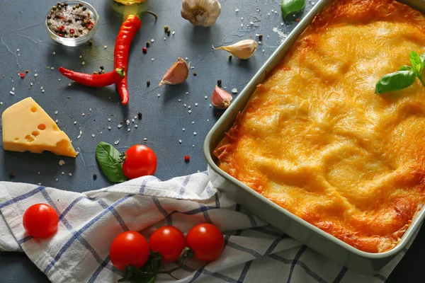 Tasty baked lasagna with spices on dark background — Stock Photo, Image