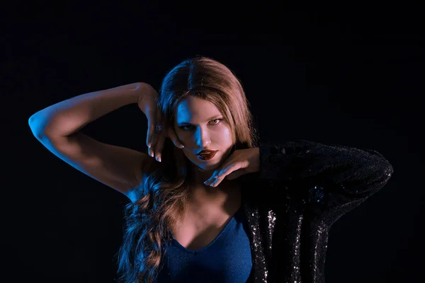 Toned portrait of stylish young woman on dark background — Stock Photo, Image