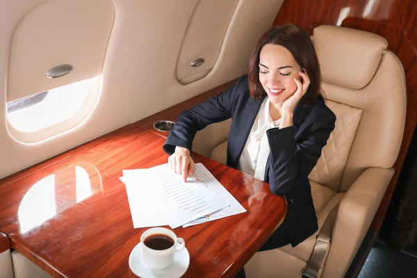 Businesswoman on board the modern private airplane — Stock Photo, Image