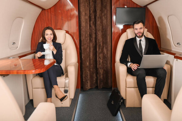 Business colleagues on board the modern private airplane
