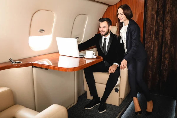 Businessman and his wife on board the modern private airplane — Stock Photo, Image