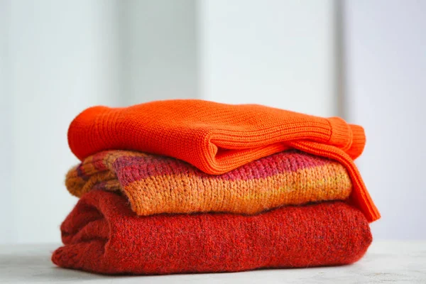 Stack of clean clothes on table in room — Stock Photo, Image