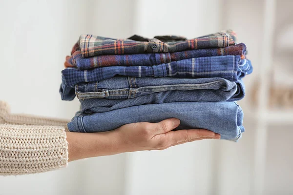 Woman with stack of clean clothes, closeup — Stock Photo, Image