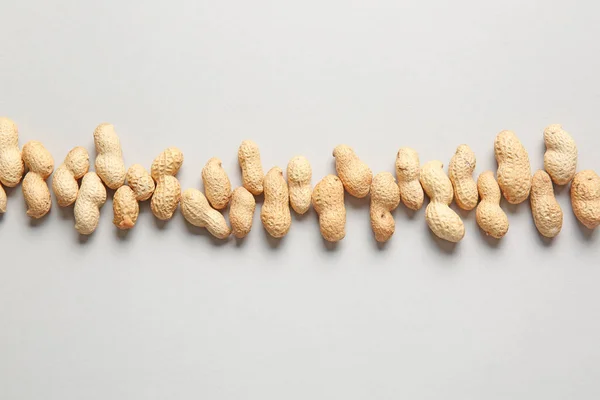 Tasty peanuts on light background — Stock Photo, Image