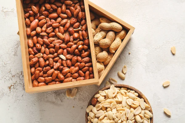 Boxes with peanuts on light background