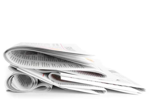 Many newspapers on table against white background — Stock Photo, Image