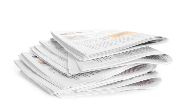 Many newspapers on table against white background — Stock Photo, Image