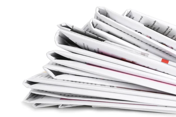 Many newspapers on table against white background — Stock Photo, Image