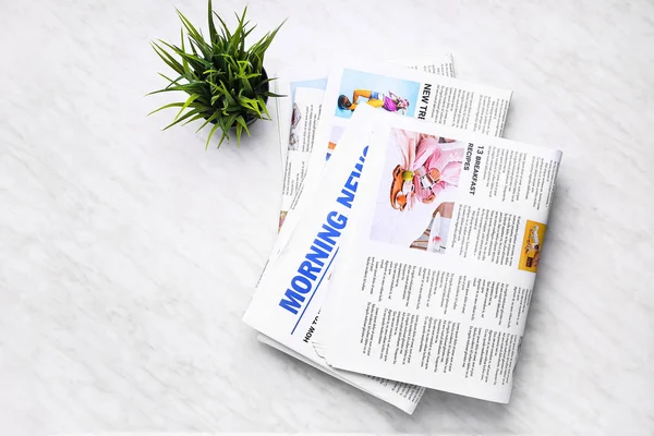 Stack of newspapers on light background — Stock Photo, Image