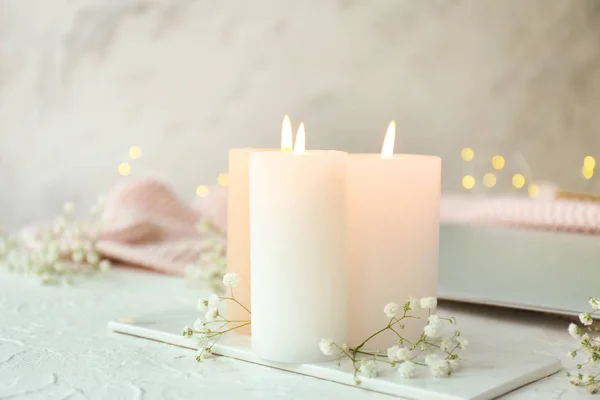 Burning candles and flowers on table — Stock Photo, Image